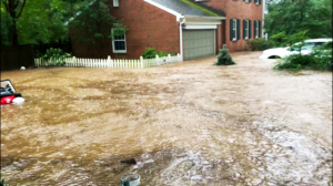 Severely flooded road and home